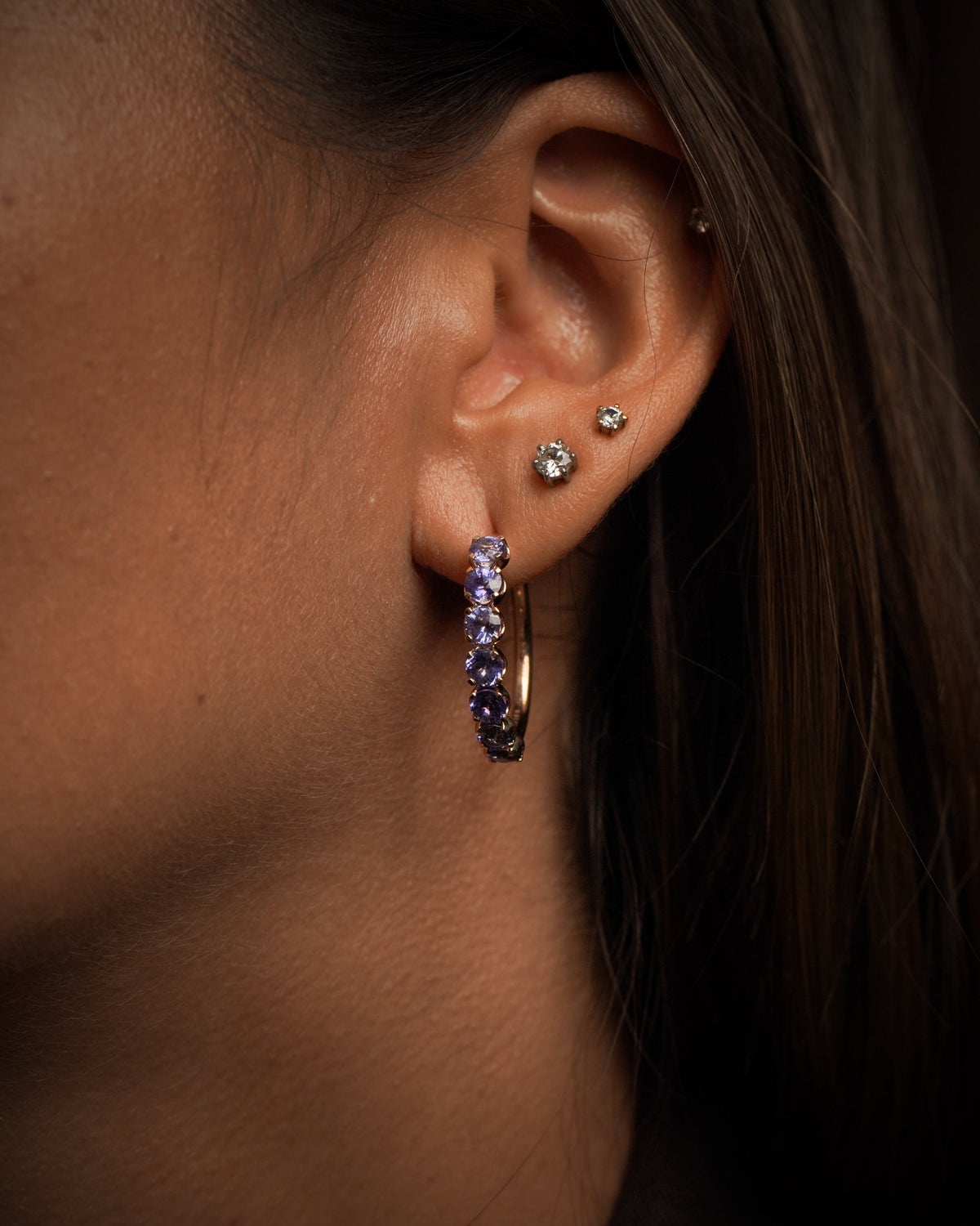 Tanzanite halo hoop earrings by Stefania’s Stones and MÉTIER worn on the ear